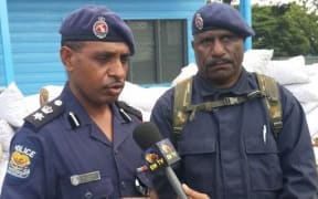Arrested former police chief of Port Moresby Andy Bawa. (Left)