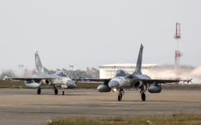 (FILES) Taiwanese air force Indigenous Defense Fighter aircraft taxi for take-off during a scramble as part of a combat readiness exercise at the Ching Chuan Kang Air Base in Taichung on January 7, 2025. Taiwan dispatched forces on February 26, 2025 in response to "live-fire" drills conducted by China off the self-ruled island, Taipei's defence ministry said, condemning the exercises as dangerous.