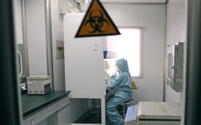 A Chinese medic testing for the swine flu H1N1 virus at a hospital in Hefei, China, in 2009.
