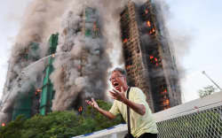 Mr Wong cries out in anguish as fire engulfs the Tai Po housing complex in Hong Kong.