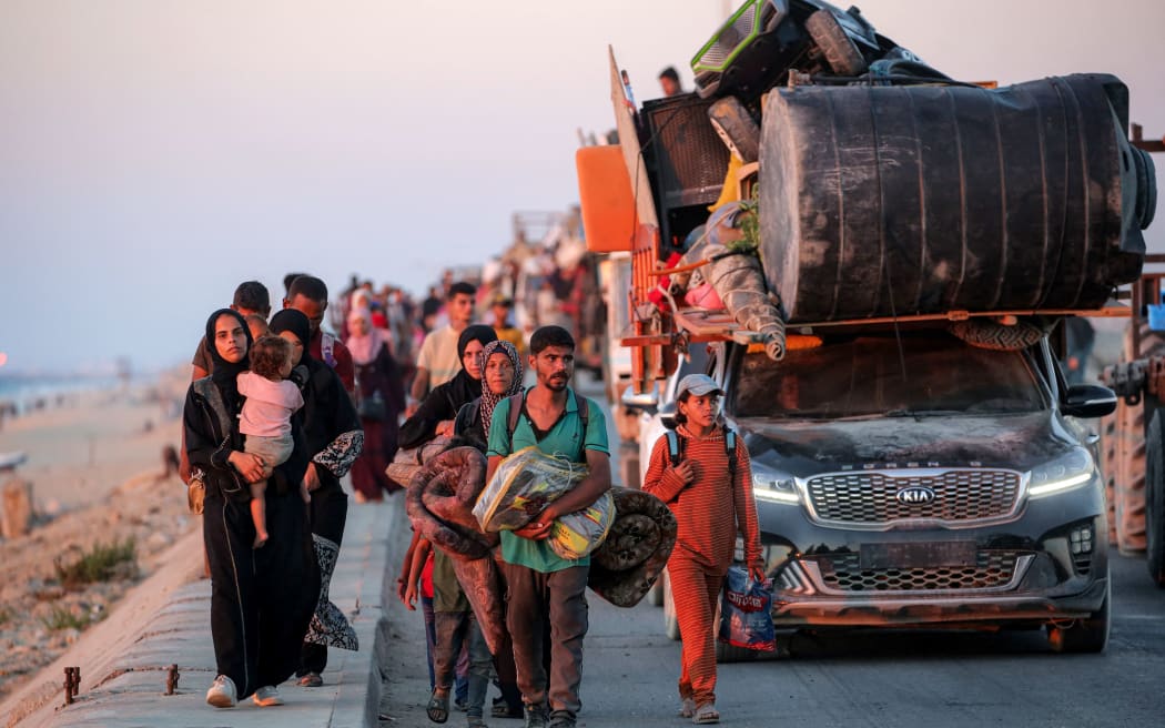 Displaced Palestinians evacuating southbound from Gaza City travel along a coastal road in Nuseirat in the central Gaza Strip on 13 September, 2025.