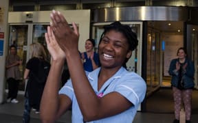 A nurse claps her hands outside Chelsea and Westminster Hospital to take part in the weekly 'Clap for our Carers' applause for the NHS and key workers on the front line of the coronavirus (Covid-19) pandemic