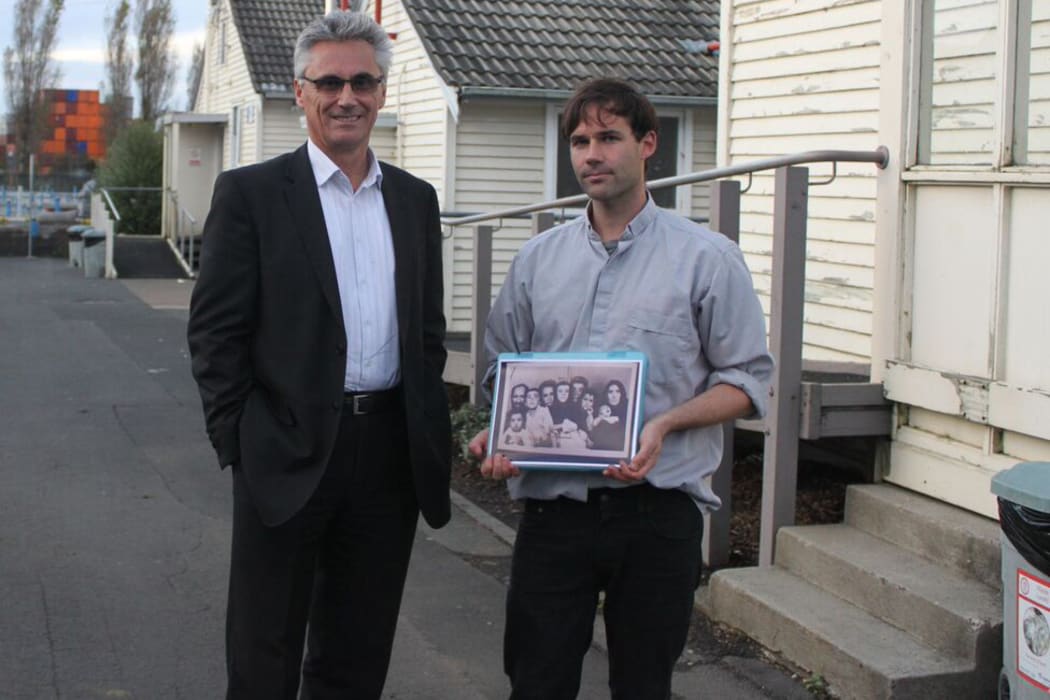 Qemajl Murati, manager of the Mangere Refugee Resettlement Centre and Murdoch Stephens, who holds a photo of a family from Afghanistan that he found in a refugee detention centre in Iran.