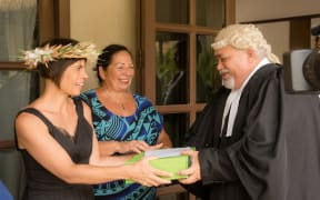 Te Vai Ora Maori members Justine Flanagan and Imogen Ingram hand Clerk of Parliament Tangata Vainerere the petition opposing the proposed chemical treatment of the Rarotonga water system.