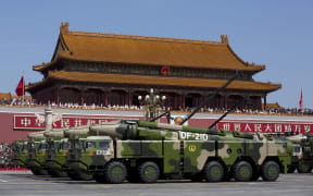 Military vehicles carrying Chinese ballistic missiles in a Beijing parade. China's new generation missiles are capable of reaching Guam and the Northern Marianas, US territories.