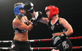 Snowboarder Hayley Holt takes on surfer Paige Hareb in a Fight For Life charity boxing event.