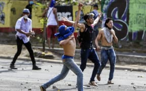 Students clash with riot police agents close to Nicaragua's Technical College during protests against government's reforms in the Institute of Social Security (INSS) in Managua on April 21, 2018.