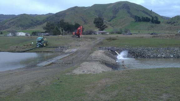The dam being emptied after the July quake.