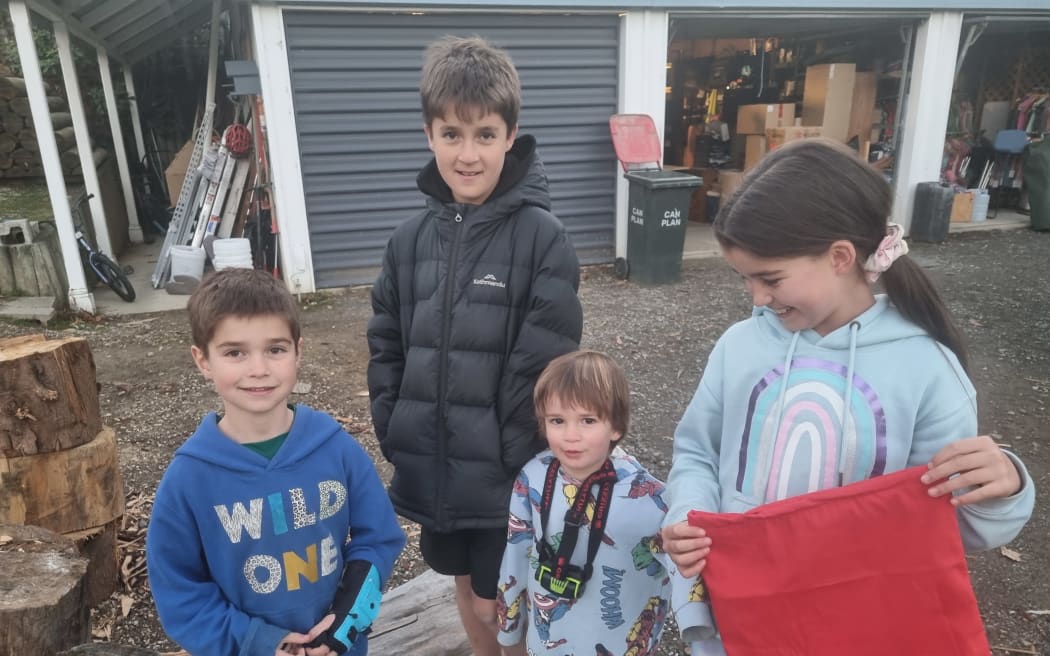 Oliver, Thomas, Mateo and Isabella Monge-Grassi with some of their Paterpillar reusable gift bags.