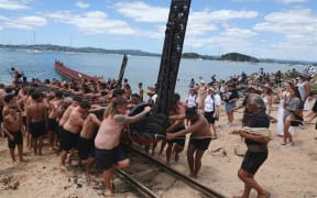 The waka Mātaatua is pulled from the water, to be returned to its whare for another year.