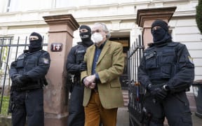 German special police forces detain Heinrich XIII Prinz Reuss after searching a house in Frankfurt / Main, western Germany, on 7 December, 2022.