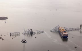 BALTIMORE, MARYLAND - MARCH 26: In an aerial view, cargo ship Dali is seen after running into and collapsing the Francis Scott Key Bridge on March 26, 2024 in Baltimore, Maryland. Rescuers are searching for at least seven people, authorities say, while two others have been pulled from the Patapsco River.   Tasos Katopodis/Getty Images/AFP (Photo by TASOS KATOPODIS / GETTY IMAGES NORTH AMERICA / Getty Images via AFP)