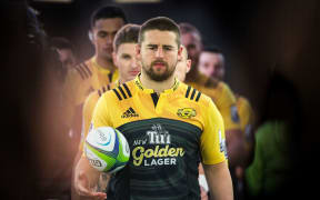 Captain Dan Coles leads the Hurricanes out onto the field.