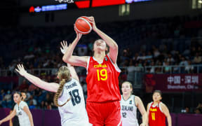 Chinese basketball player Zhang Ziyu (C) shooting past New Zealand's Elise Jayne Carline during their 2024 FIBA Under-18 Women's Asia Cup match between China and New Zealand in Shenzhen.