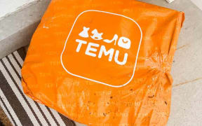 An orange bag with Temu logo