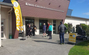 People queue to sign in at Tui Ora's pop up clinic in Waitara.