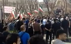 This video grab taken from UGC images posted on social media and verified by AFPTV teams in Paris on February 21, 2026, shows Iranians clashing near the Department of Aerospace Engineering of Sharif University in Tehran. As some repeat "disgraceful" in Farsi, a common chant in anti-government protests, others wave the flag of the Islamic Republic of Iran. Iranian students chanted anti-government slogans at rallies for people killed during a recent wave of demonstrations, local and diaspora media reported February 21, 2026, as groups protesting the clerical leadership faced off with others voicing support for the government. (Photo by UGC / AFP) / - Israel OUT / - ISRAEL OUT / ISRAEL OUT - XGTY / RESTRICTED TO EDITORIAL USE - MANDATORY CREDIT AFP -  SOURCE: UGC ANONYMOUS - NO MARKETING - NO ADVERTISING CAMPAIGNS  - DISTRIBUTED AS A SERVICE TO CLIENTS - NO RESALE - NO ACCESS ISRAEL MEDIA/PERSIAN LANGUAGE TV STATIONS OUTSIDE IRAN/ STRICTLY NO ACCESS BBC PERSIAN/ VOA PERSIAN/ MANOTO-1 TV/ IRAN...