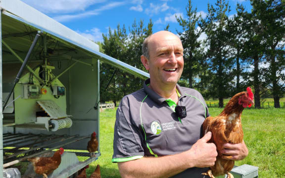 Lance Gillespie with chicken trailer and resident chook