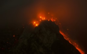 A long expoure photo shows Mount Sinabung on 14 June 2015.