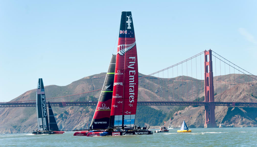 Emirates Team New Zealand and Oracle Team USA pass the Golden Gate Bridge, San Francisco.