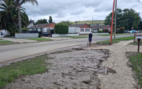 A torn up footpath covered in mud