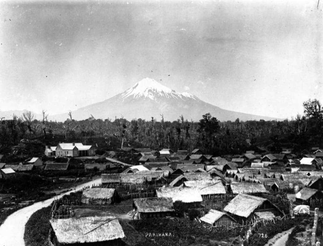 Parihaka Pa, circa 1900, with Mount Taranaki - taken by an unidentified photographer.