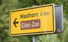 A sign showing the way to the Eifel Zoo in Lunebach, western Germany.