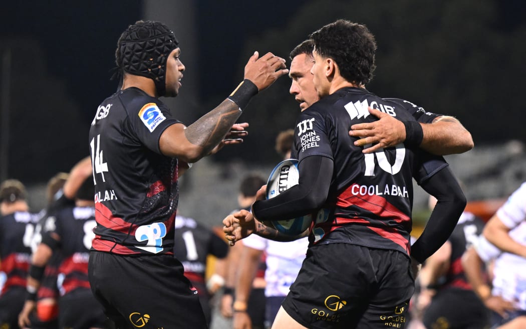 Rivez Reihana of the Crusaders celebrates with team mates after scoring a try.