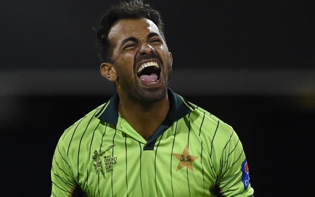 Pakistan's Wahab Riaz celebrates the wicket of Zimbabwe's Tawanda Mupariwa.