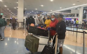 Passengers pose at the airport after Niue reopens its border.