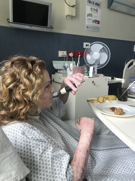 Kelsey Waghorn learning to feed herself in hospital.