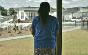 Maria looks out over the temporary accommodation she calls home for now.