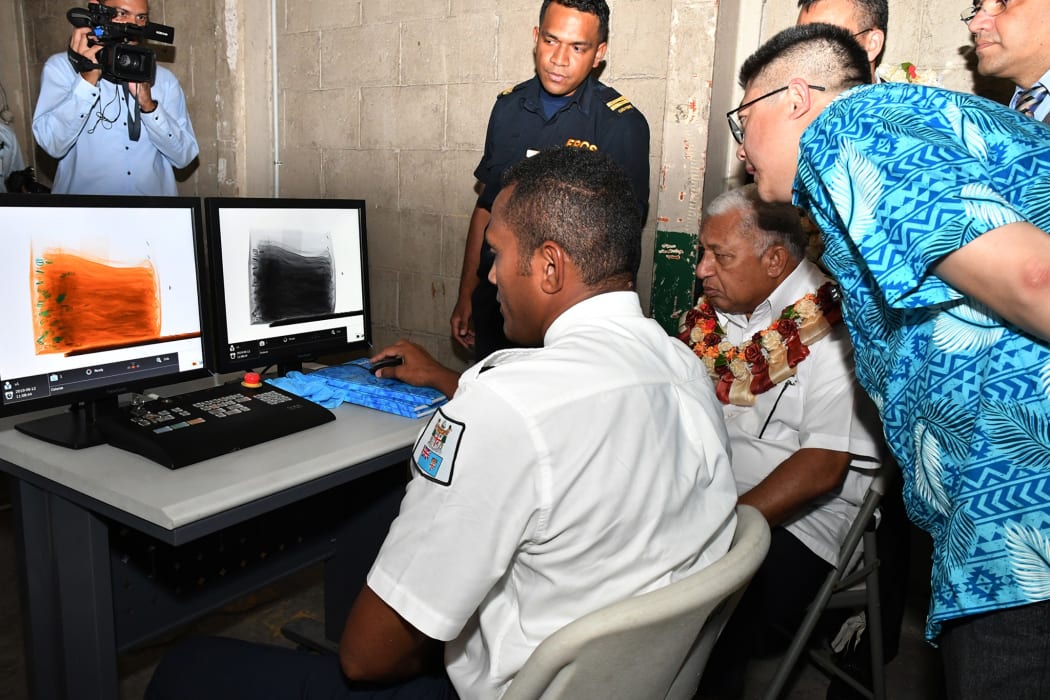 Prime Minister Frank Bainimarama (with garland) is shown what the new non-intrusive inspection x-ray can do at the Suva Wharf this week.