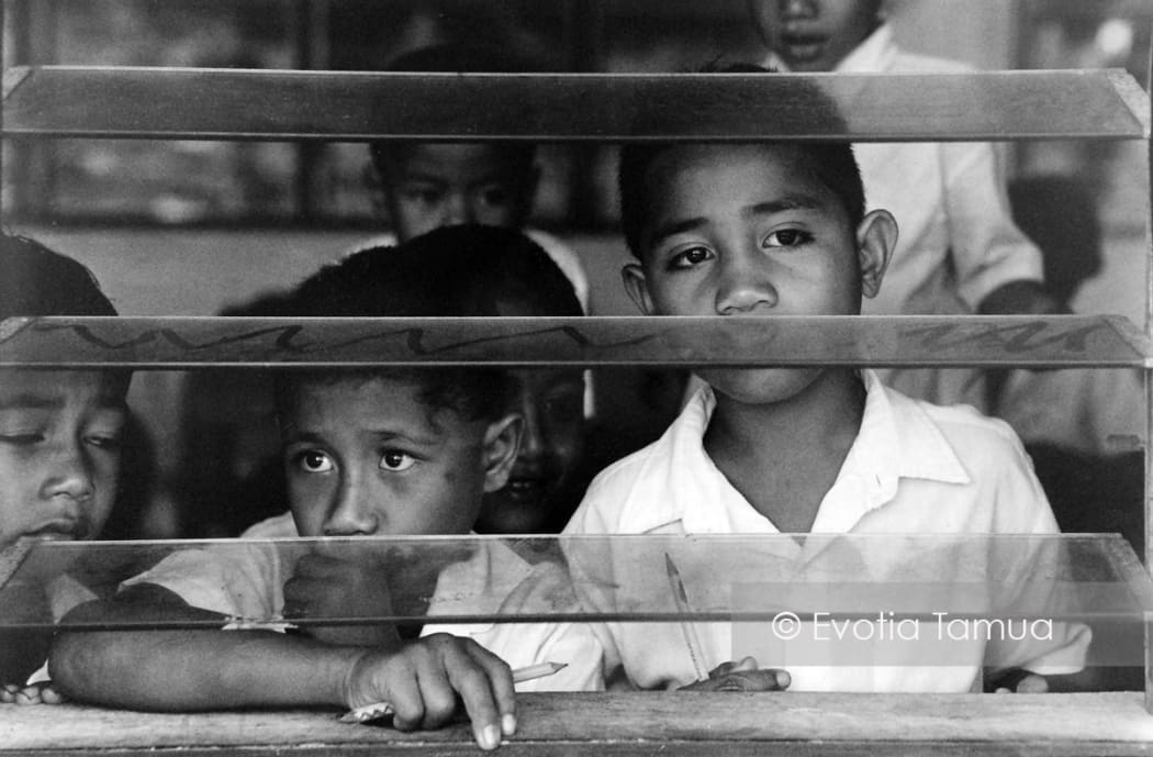 Salelesi Primary school pupils look out of louvre windows in 1994.