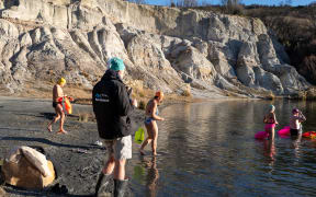 Athletes at the New Zealand ice swimming championships prepare to plunge into Otago's Blue Lake near St Bathans.