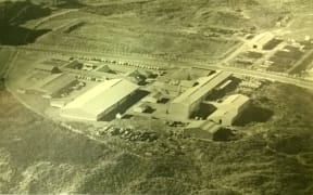 Paritutu site in the 1960s showing chemical drums stacked at the boundary.