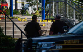 Officials with the Oakland County Sheriff's Department, Rochester Hills Fire Department and other jurisdictions secure the scene of a shooting at the Brooklands Plaza Splash Pad, Saturday, June 15, 2024, in Rochester Hills, Mich. (Katy Kildee/Detroit News via AP)