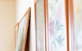 artwork in frames on the wall