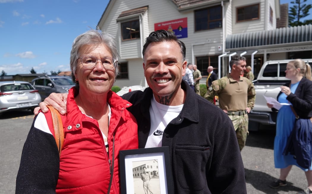 Mihiteria King and her son Scott Douglas hold a picture of Hemi Kingi. RNZ/Jimmy Ellingham