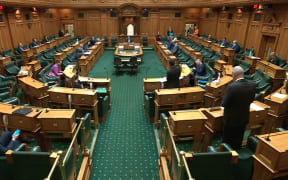 A much smaller number of MPs than the usual 120 are spread out through the debating chamber in an effort to comply with Covid-19 health regulations