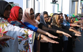 Indian women hold out their hands as they stand in a line to take part in a "women's wall" protest in Kochi in southern Kerala state.