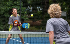 Two women playing pickleball