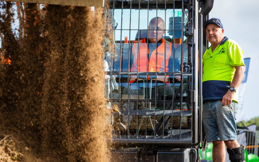 Prime Minister Christopher Luxon scoops dirt in a digger at Field Days in Feilding on 14 March 2024.
