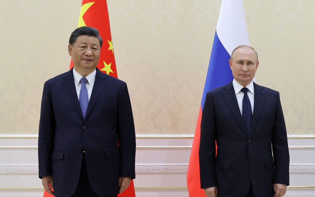 China's President Xi Jinping (left) and Russian President Vladimir Putin (right) pose for a photo after they met on the sidelines of the Shanghai Cooperation Organisation (SCO) leaders' summit in Samarkand, Uzbekistan on 15 September, 2022.