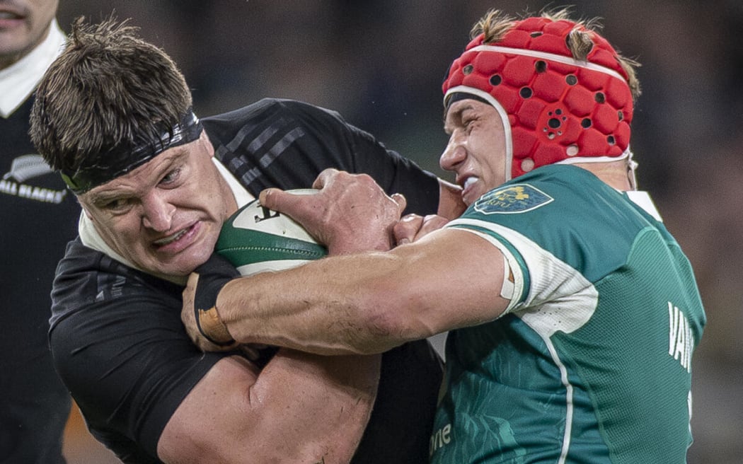 All Black Scott Barrett is tackled by Josh van der Flier of Ireland.