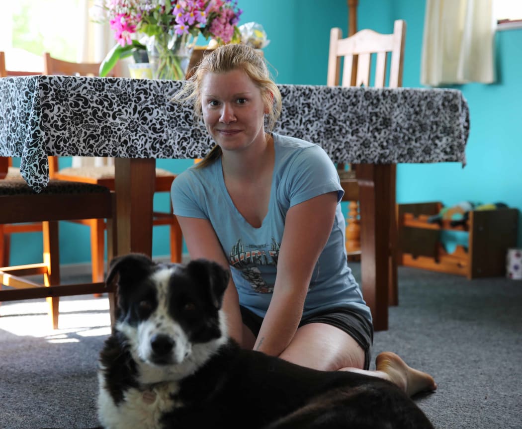 And image of dale Coppin in her house with her dog.