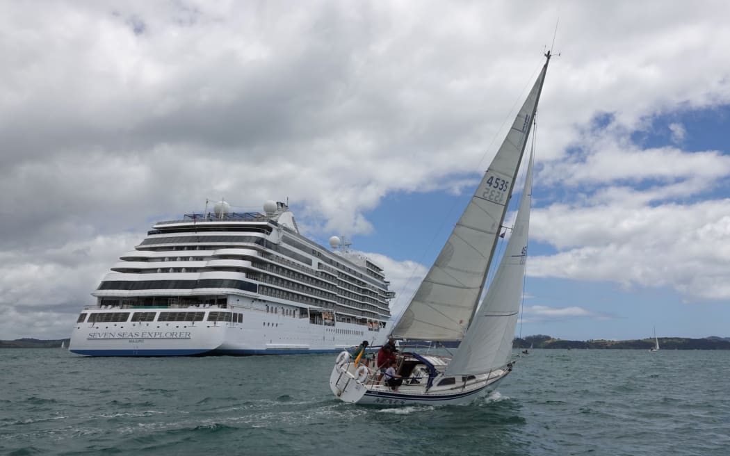 Last year’s classic invitational winner, Nexus, skippered by Ōpua’s Cees Romeyn, passes the cruise ship Seven Seas Explorer.