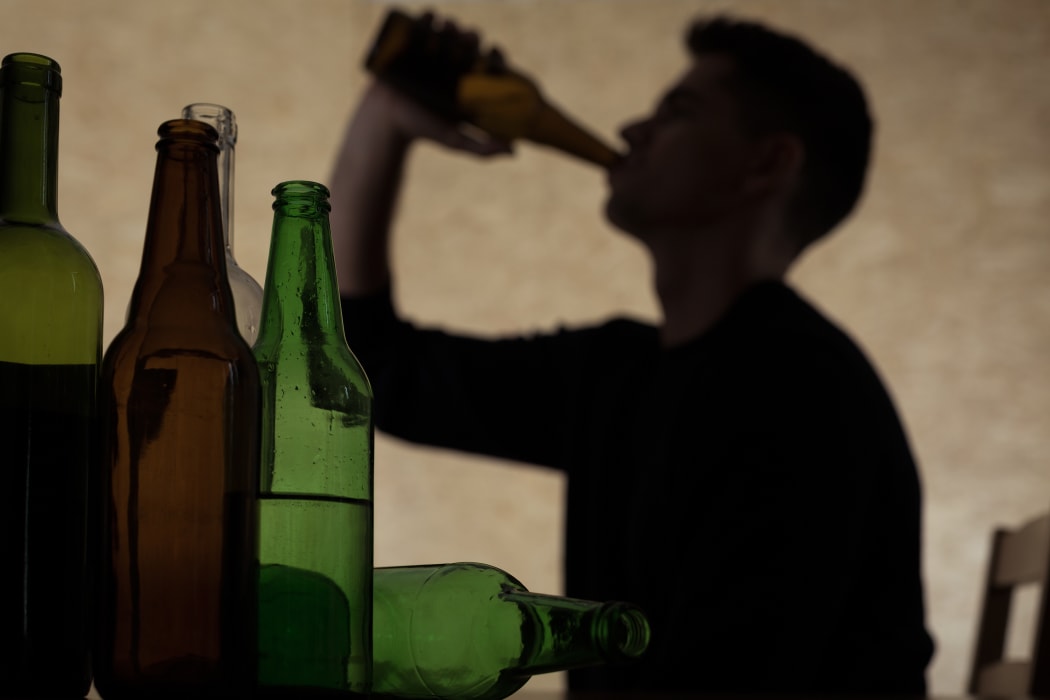 Teen chugging a beer.