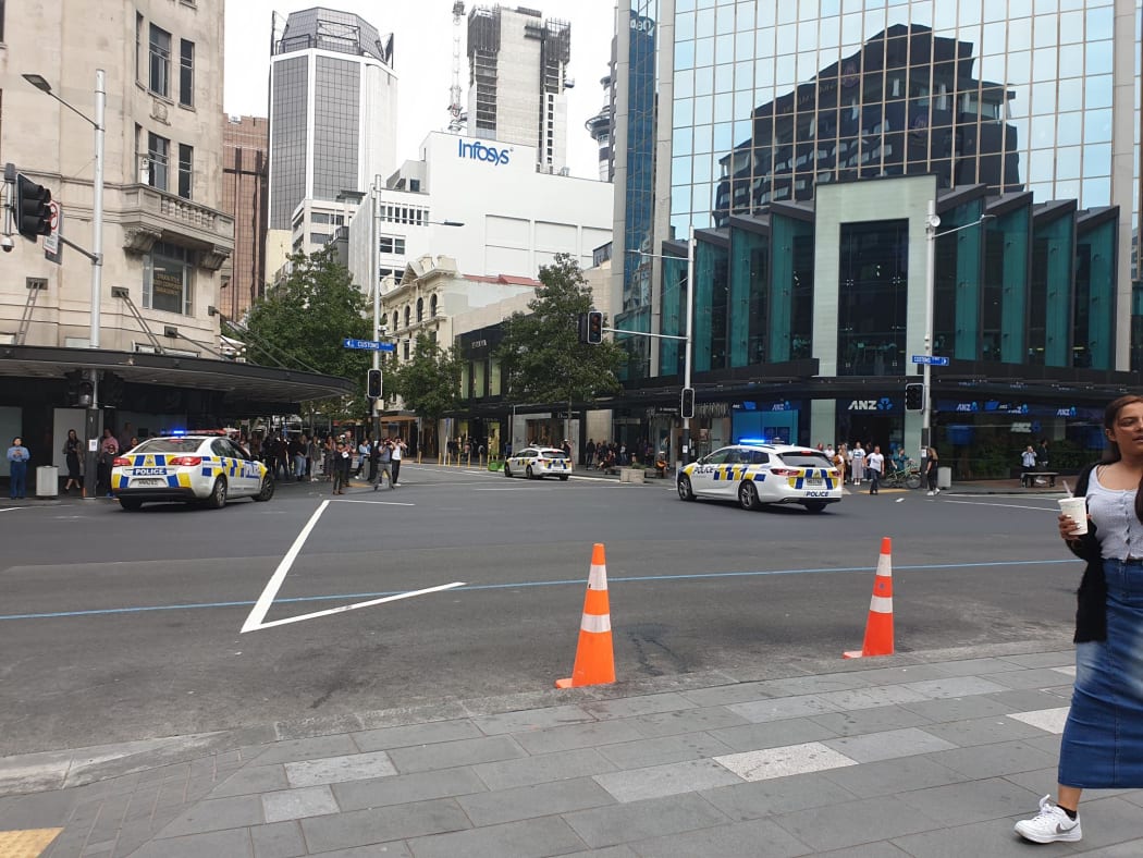 Police clear Queen Street for the climate strikers.