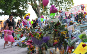 People in Uvalde visit memorials for victims of the May 24th mass shooting at Robb Elementary School, where 19 children and two teachers were killed.